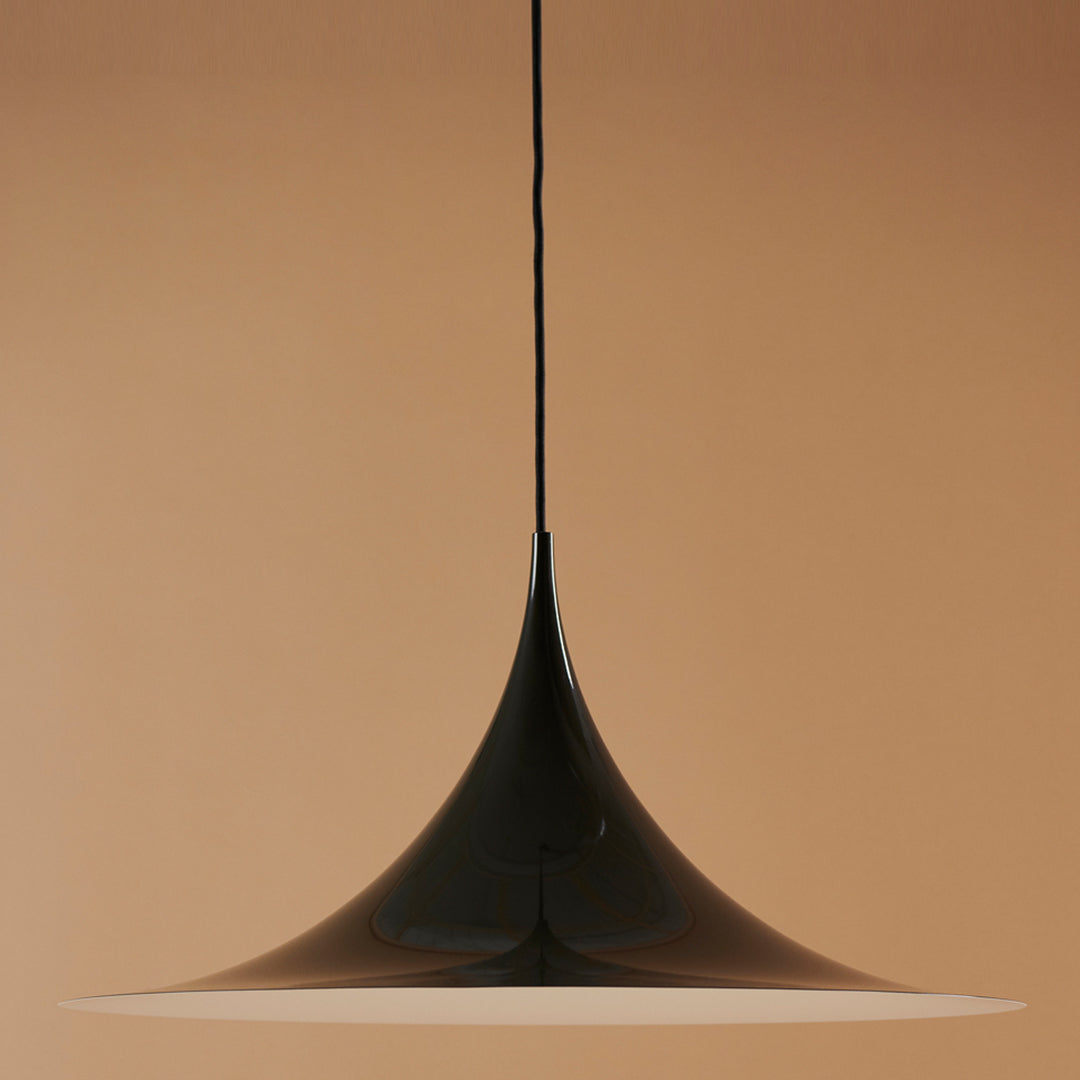 Sleek black pendant light with a smooth, conical shape, complemented by a soft white glow.