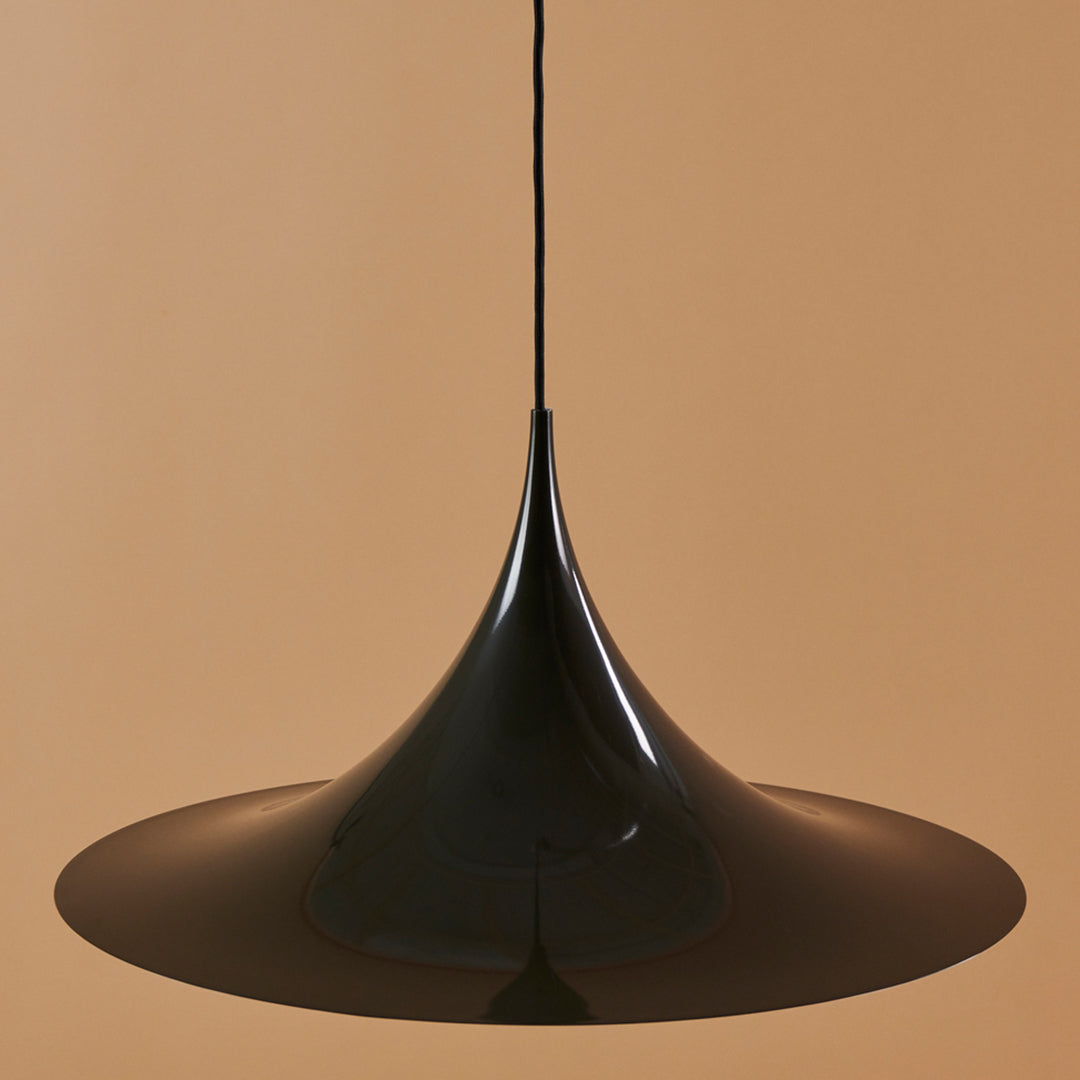 Sleek black pendant light with a smooth, conical design against a warm beige background, perfect for modern decor.