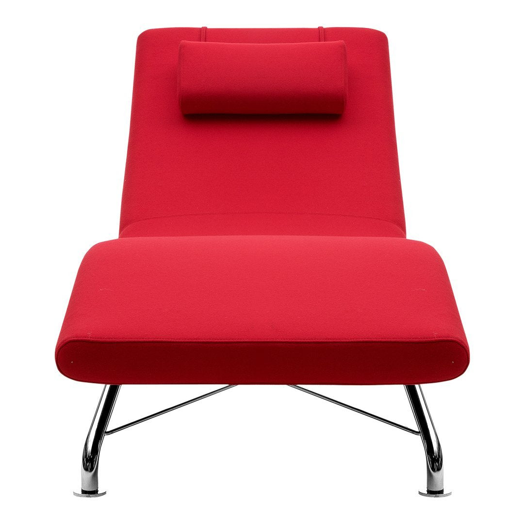 Bright red chaise lounge with a sleek design and chrome legs, featuring a matching headrest for added comfort.