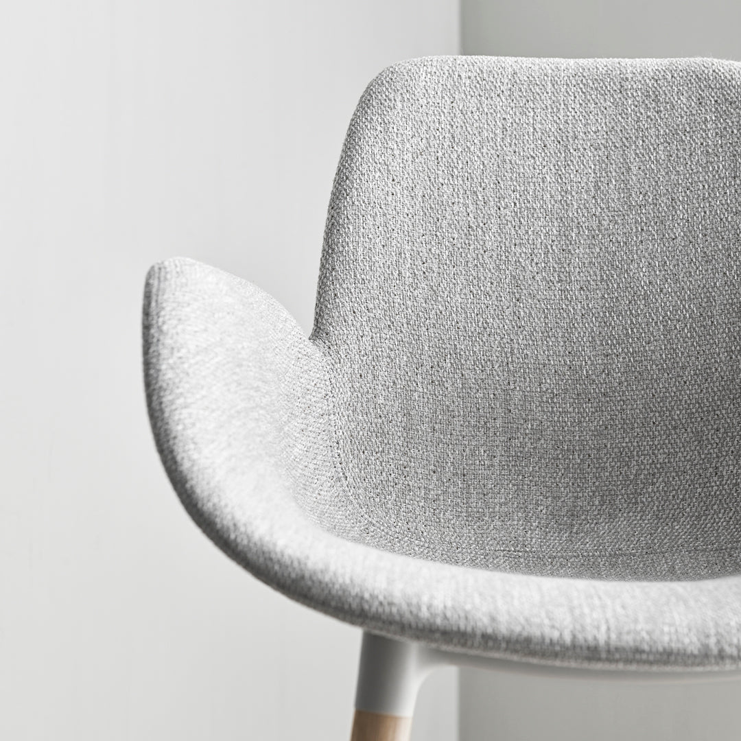 Grey textured chair with a smooth, minimalist design and subtle fibers, perfect for modern interiors.