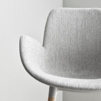 Grey textured chair with a smooth, minimalist design and subtle fibers, perfect for modern interiors.