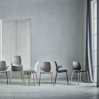 Contemporary chairs in varying shades of gray, black, and beige, showcasing sleek designs against a minimalist backdrop.