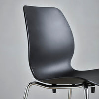 "Black modern chair with a sleek, curved design and shiny metal legs, offering a minimalist aesthetic."