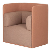 "Soft peach and tan upholstered armchair with a minimalist design and smooth, seamless contours."