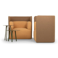 Orange and brown upholstered armchair with a modern design, complemented by minimalist green side tables.