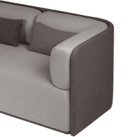 Modern two-toned sofa in light gray and dark gray with soft fabric upholstery and curved design.