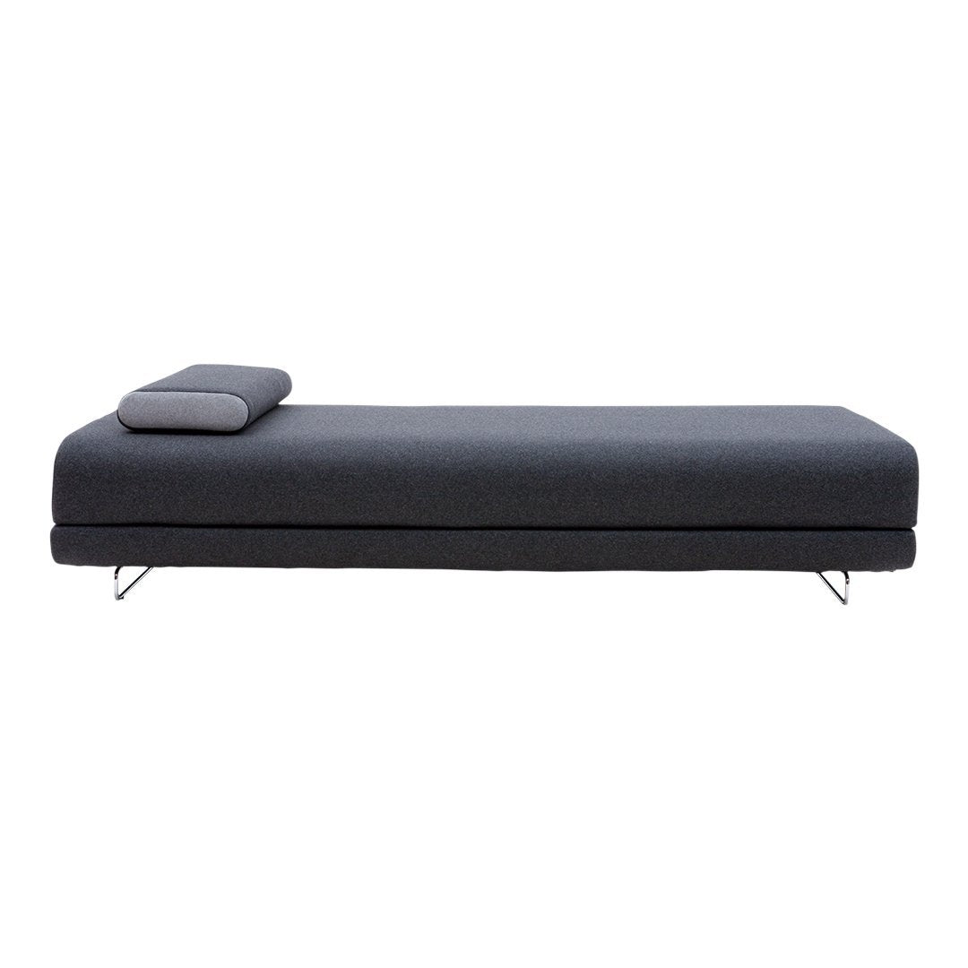 Sleek dark gray chaise lounge with minimalistic design and subtle texture, featuring a simple, modern aesthetic.