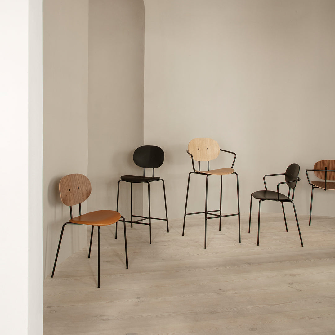 "Set of modern chairs featuring natural wood, black, and tan colors with simple, elegant patterns."