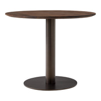 Round wooden dining table with a rich walnut finish and a sleek black metal base, showcasing a modern minimalist design.
