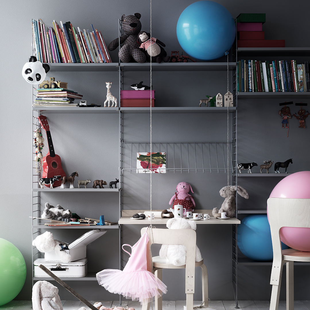 Colorful children's playroom with pastel pink, blue, and green elements, featuring playful patterns and soft textures.