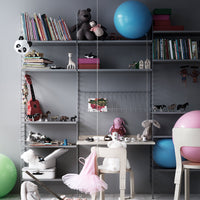 Colorful children's playroom with pastel pink, blue, and green elements, featuring playful patterns and soft textures.