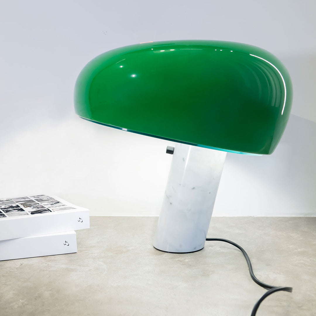 Green dome-shaped lamp with a sleek white marble base, perfect for modern decor.