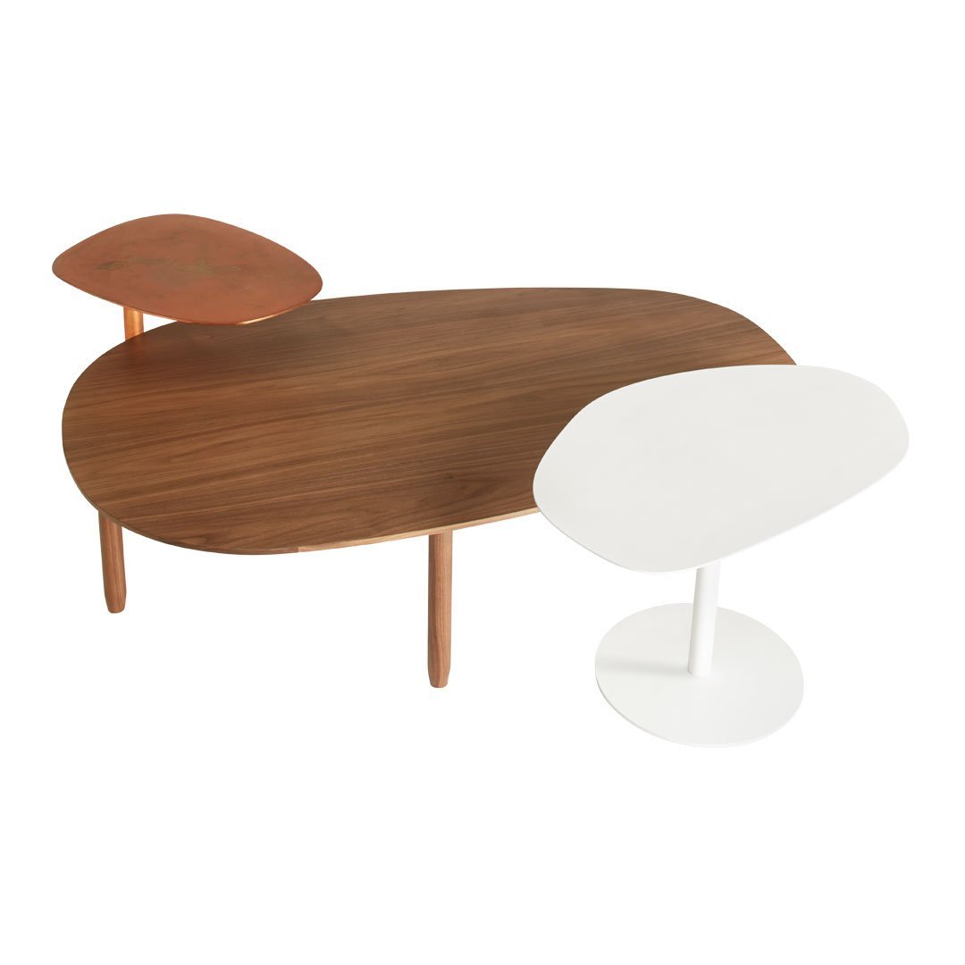 Modern coffee table features walnut wood, copper accents, and a sleek white top, blending warm and cool tones.