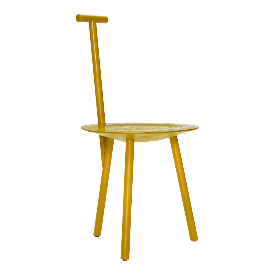 Bright yellow minimalist chair with a round seat and unique handle design, perfect for modern decor.