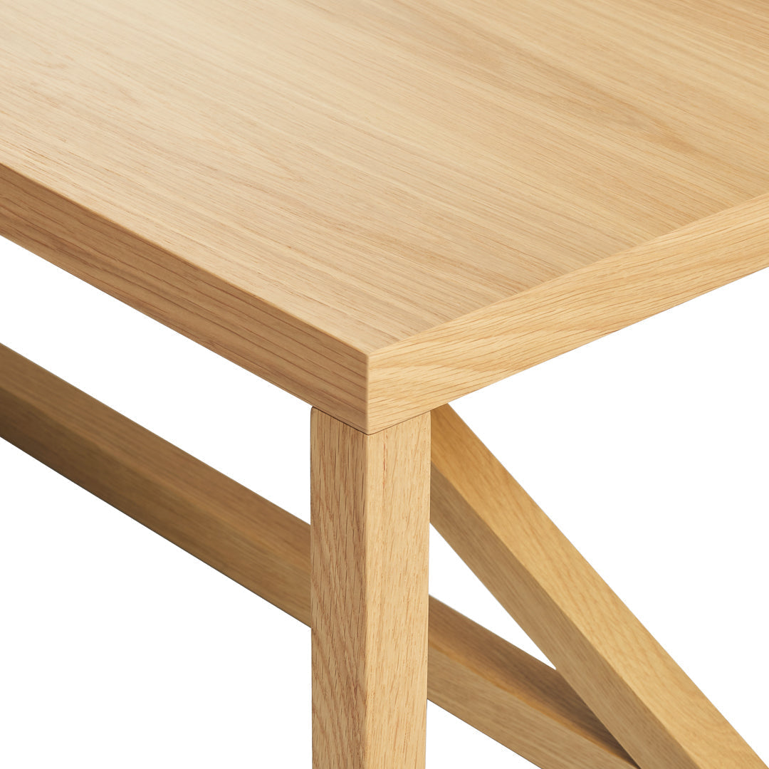 Light oak wood table with a smooth, natural finish and clean lines. Simple, minimalist design featuring subtle grain patterns.