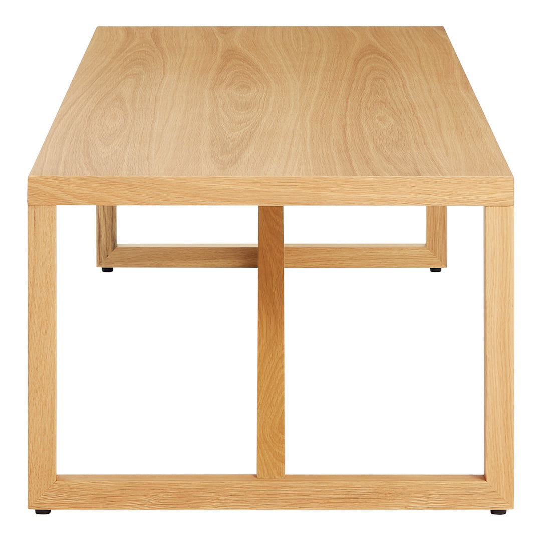 Light oak wood coffee table with a smooth surface and minimalist design, featuring a simple square base in natural tones.