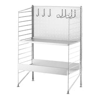 Silver wire shelving unit with a perforated back, featuring hooks and two shelves in a sleek, modern design.