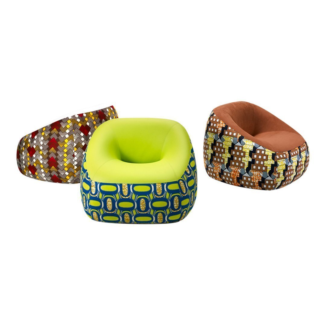 Colorful cushions featuring geometric patterns in vibrant hues of yellow, brown, red, and blue. Perfect for any decor.