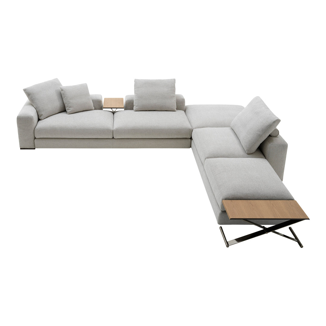Light gray sectional sofa with plush cushions and a sleek wooden side table, modern design and minimalistic style.
