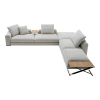Light gray sectional sofa with plush cushions and a sleek wooden side table, modern design and minimalistic style.