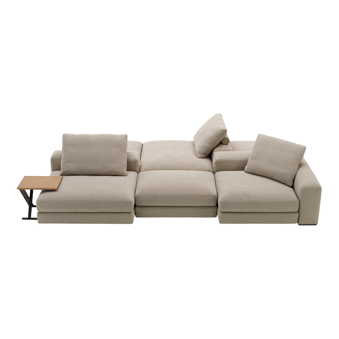 Beige sectional sofa with soft cushions and a minimalist wood accent table. Modern and versatile design for any space.