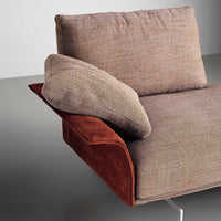 Brown textured upholstery with a rust-colored suede accent cushion. Contemporary and cozy design.