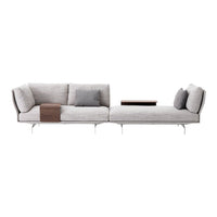 Modern light gray sectional sofa with sleek lines, plush cushions, and minimalistic wooden accent table.