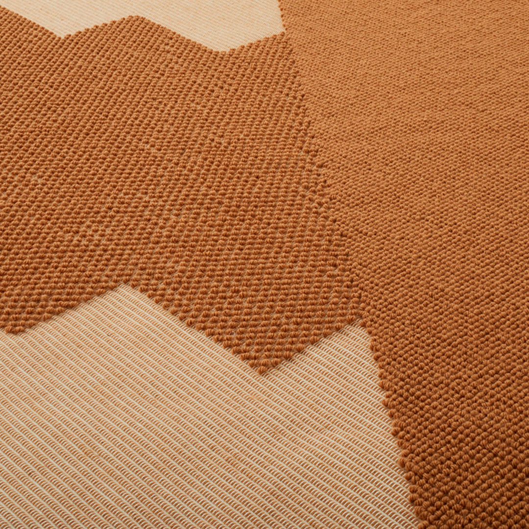 Geometric pattern rug featuring warm terracotta and soft beige tones in a textured design. Ideal for stylish interiors.