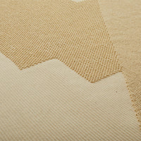 Beige textured fabric with a zigzag pattern, featuring contrasting woven and smooth sections. Ideal for cozy decor.