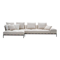 Beige sectional sofa with plush cushions and sleek black metal accents, featuring a minimalist design.