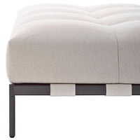 Light beige tufted cushion on a sleek black metal frame with contrasting fabric accents.