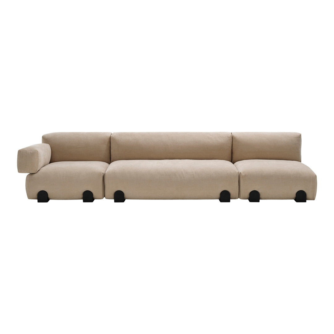 Beige modular sofa with soft, textured fabric and rounded edges, featuring black circular feet for a modern touch.