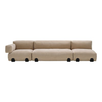 Beige modular sofa with soft, textured fabric and rounded edges, featuring black circular feet for a modern touch.