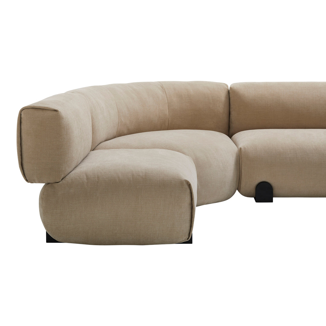 Beige curved sofa with a smooth, textured fabric and minimalist black legs, ideal for modern decor.