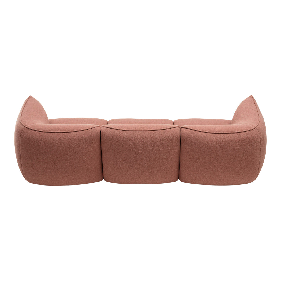 Soft pink three-seater sofa with curved, minimalist design and smooth texture. Ideal for modern interiors.