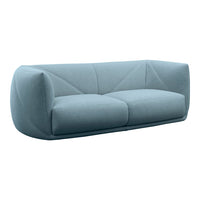 Soft blue fabric sofa with a modern, sculptural shape and geometric stitching pattern. Ideal for contemporary interiors.