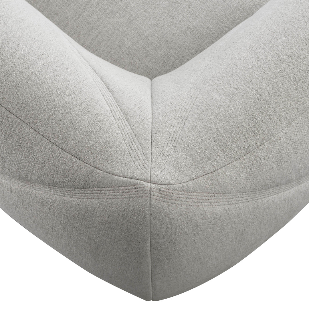 Stylish light gray upholstered corner detail with subtle texture and clean lines, perfect for modern decor.