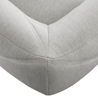 Stylish light gray upholstered corner detail with subtle texture and clean lines, perfect for modern decor.