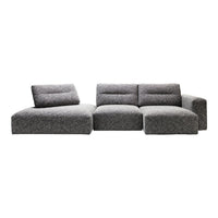 Modern grey sectional sofa with soft, textured fabric and minimalist design. Ideal for contemporary living spaces.
