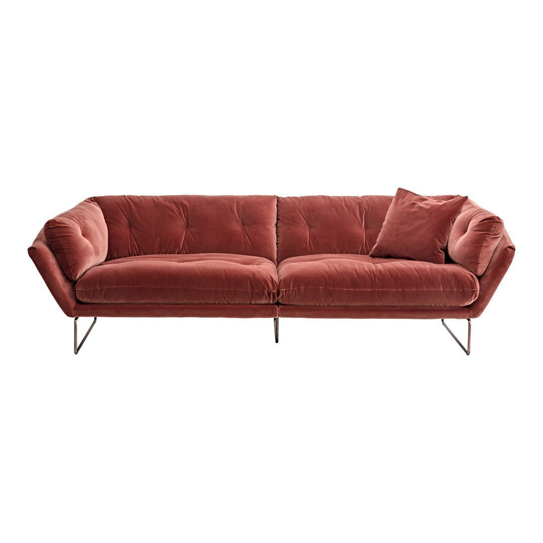 Modern velvet sofa in rich rust color with a smooth texture and subtle tufted design. Perfect for stylish living spaces.