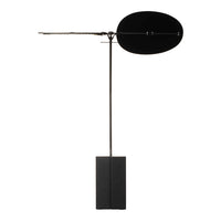 Black modern floor lamp with sleek, minimal design and smooth round shade, balanced on a rectangular base.