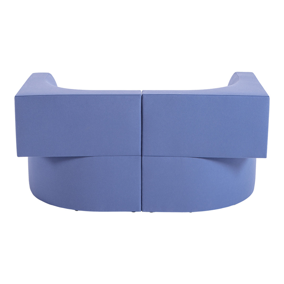Curved blue sofa with smooth texture and minimalist design, featuring soft pastel tones and clean lines.