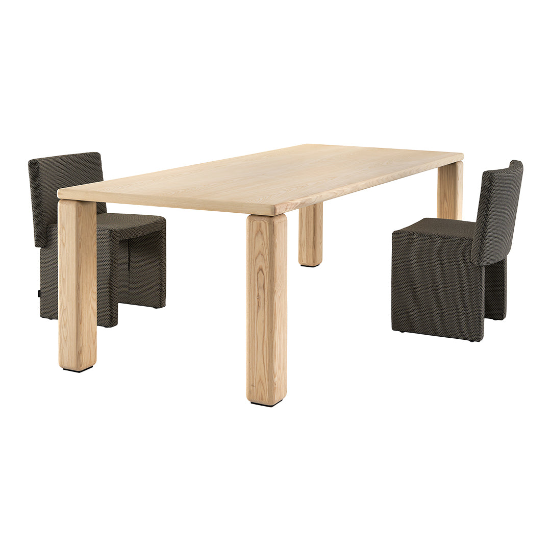 Light natural wood dining table with gray patterned upholstered chairs. Modern, minimal design. Perfect for any space.
