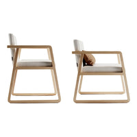Light gray cushioned chair with natural wood frame, featuring clean lines and minimalist design. Ideal for modern decor.