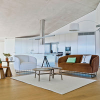 Contemporary white and brown sofas with geometric patterns, set on a light wood floor and neutral rug.