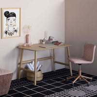 Wooden desk with beige and pink accents, patterned black and white flooring, featuring minimalistic decor.