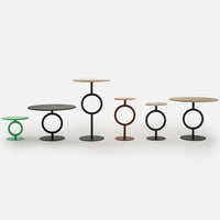 Colorful modern side tables featuring black, green, brown, and natural wood finishes with circular patterns.