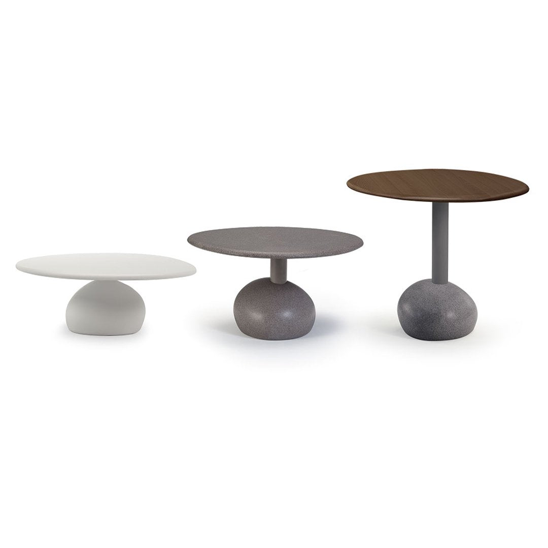 Three modern side tables in white, gray, and brown with smooth tops and rounded bases. Stylish and minimalist design.