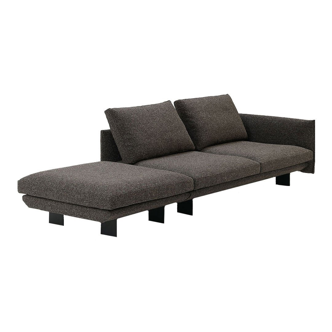 Modern gray sectional sofa with a sleek design and textured fabric, featuring black legs for a contemporary look.