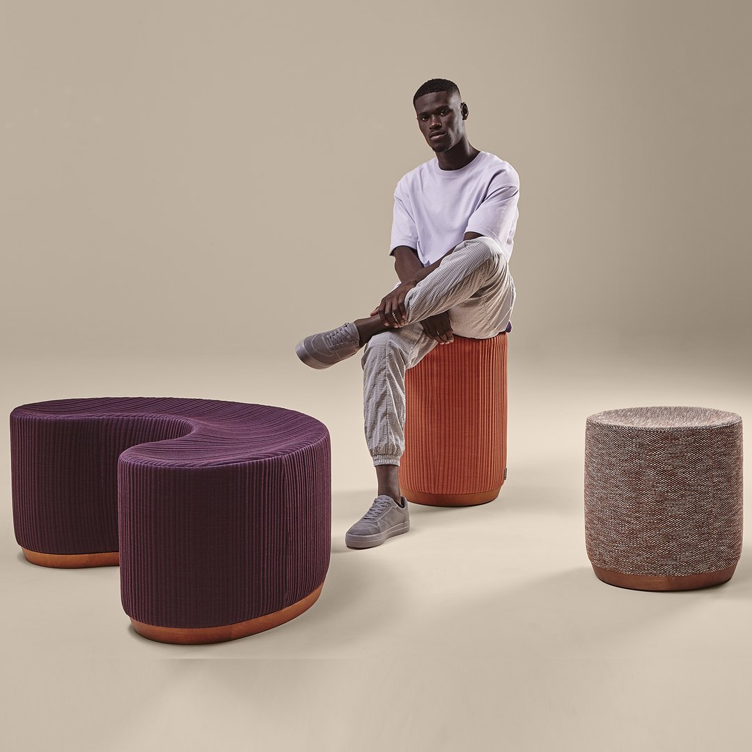 Vibrant purple and warm orange seating with subtle textured patterns, enhancing modern decor aesthetics.